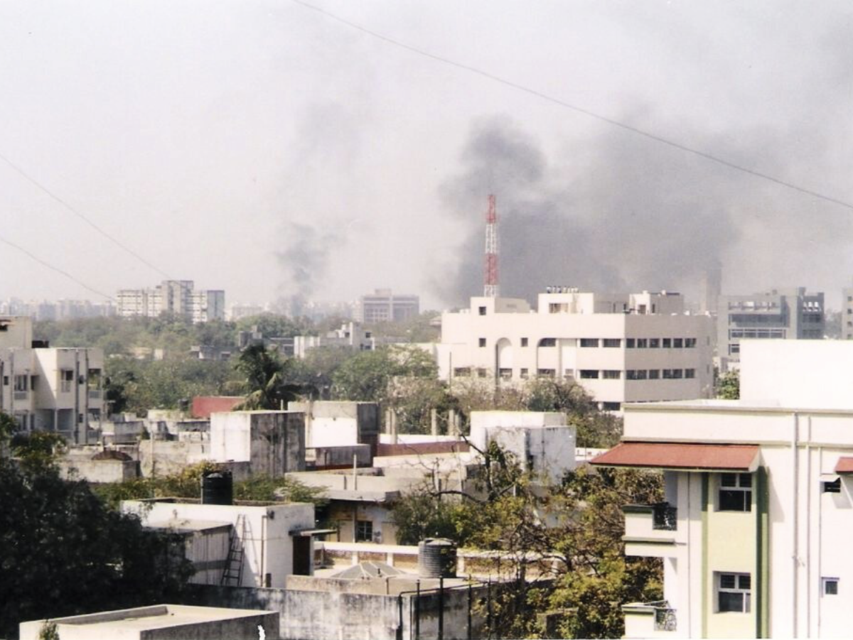 The skyline of Ahmedabad filled with smoke as buildings are set on fire by rioting mobs in 2002.